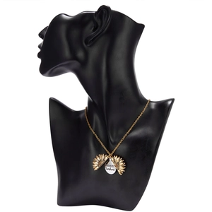 Golden sunflower necklace with engraved 'You Are My Sunshine' pendant on black mannequin