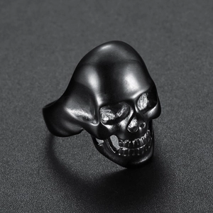 Detailed macro shot of a black skull ring in matte stainless steel with gothic details