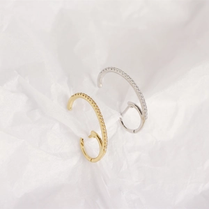 Macro view of gold and silver S925 sterling silver ear cuffs with micro-pave zircons