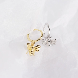Close-up of S925 sterling silver bee earrings in gold and silver finishes