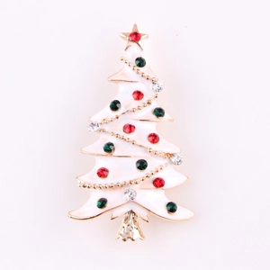 Detail of a white enamel Christmas tree brooch with colorful rhinestones on a gold base