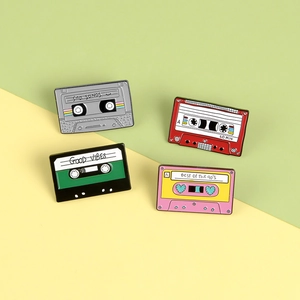 Set of four colorful retro cassette tape enamel pins with nostalgic 90s vibes lettering