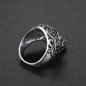 Vintage stainless steel skull ring with red CZ eyes and intricate floral engraving