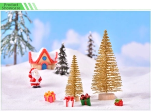 Miniature Christmas scene featuring golden sisal trees and colorful gift boxes on white snow