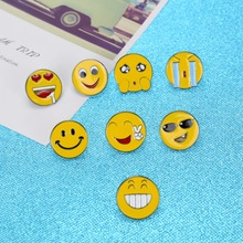 Set of 8 cute yellow enamel smiley face pins displayed on a blue textured background