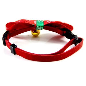 Close-up of adjustable red Christmas pet collar with snowflake patterns and gold bell detail