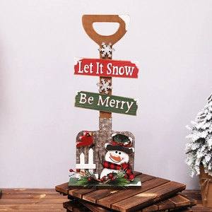 Christmas snowman shovel decoration with Let It Snow sign on rustic wooden background