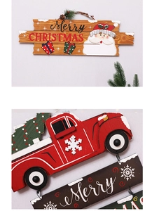 Detail of wooden Merry Christmas sign and red truck ornament for tree decoration