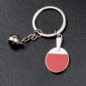 Silver metal table tennis racket keychain with red paddle and small bell on leather