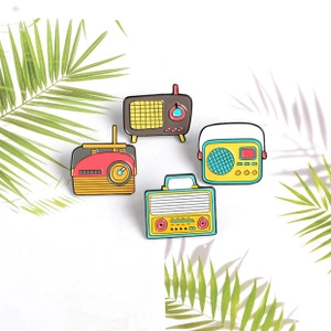 Set of four vintage radio enamel pins in retro colors on a white background with leaf shadows