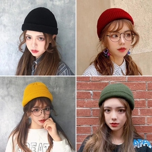 Detail view of cotton knit bucket hats in black, red, yellow and green colors