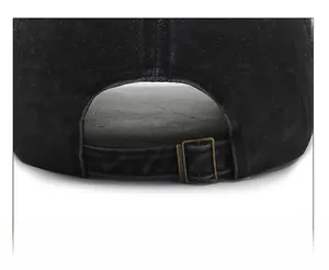 Detail of adjustable metal buckle on washed black denim baseball cap for custom fit