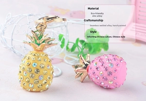 Detailed macro view of rhinestone pineapple keychains with gold lobster clasps and rings