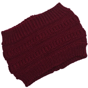 Detailed macro view of the thick burgundy cable knit texture and ribbed cuff design