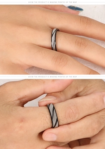 Détail de la bague en acier titane noir et argent montrant des rainures diagonales