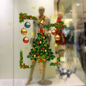 Detail of festive Christmas tree glass sticker with golden balls and snowflakes on window