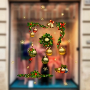 Detail of Christmas window stickers featuring golden ornaments, bells, and pine wreaths