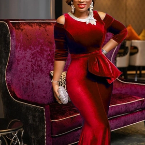 Close-up of deep red velvet dress with silver sequin neckline and waist ruffle detail