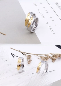 Detail of silver stainless steel couple rings with Forever Love gold inlay and small zircon