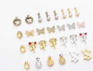 Close-up of assorted butterfly and heart nail art charms with pearls and rhinestones