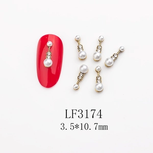 Macro detail of long nail art charms with pearls and rhinestones, size 3.5x10.7mm