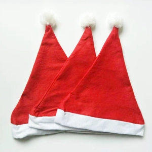 Three classic red non-woven Christmas hats with white trim and pom-poms on white background