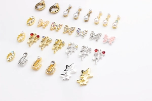 Close-up of assorted alloy nail charms with pearls, stars, and butterflies for DIY art