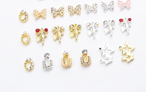 Macro view of butterfly alloy nail charms with pearls and rhinestones decoration