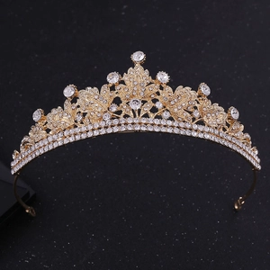 Detailed view of bridal crown with gold leaf patterns and shimmering rhinestones
