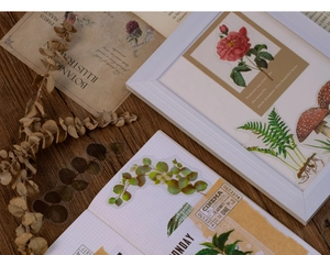 Detail of botanical PET stickers with floral and fern designs on vintage wood texture