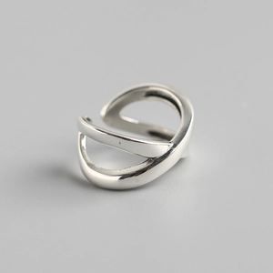 Close-up of minimalist S925 sterling silver ring featuring a crossed X-shape design