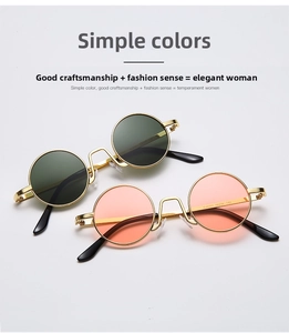 Detailed view of metal round frame sunglasses with dark green and orange pink lenses