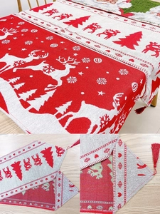 Detail of Christmas table runner with tassels, jacquard snowflake patterns and Merry Christmas text