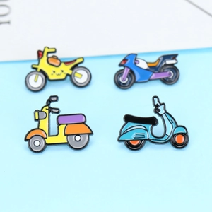 Set of four colorful enamel motorcycle and scooter lapel pins on light blue background