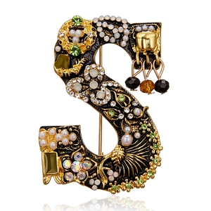 Vintage gold S-letter brooch with black enamel, pearls, and colorful rhinestones
