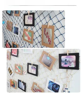 Detail of nautical fishing net photo wall with colorful paper frames and wooden clips
