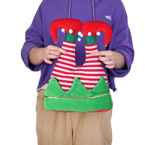 Detail of Christmas elf hat featuring striped legs, white pom-poms, and golden bells