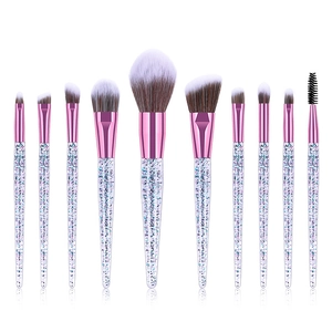 Detailed row of 10 glitter eye makeup brushes with pink ferrules on white background