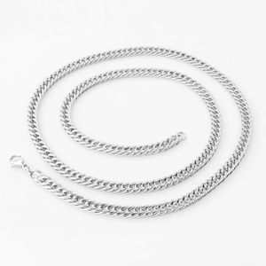 Macro shot of a classic silver double buckle Cuban link necklace with lobster clasp
