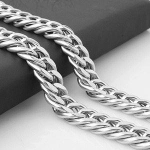 Macro shot of silver polished double-link chain showing thick metal texture and craftsmanship