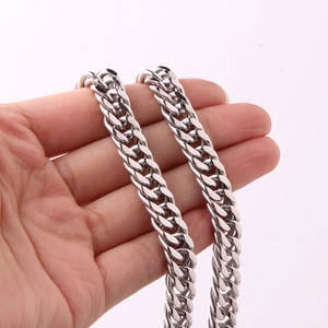Close-up of polished silver double buckle chain links with a high-gloss metallic finish