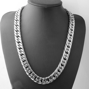 Polished silver double buckle Cuban link necklace for men on a black mannequin