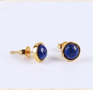 Close-up of lapis lazuli round stud earrings with golden finish settings and pin backs