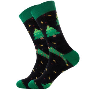 Close-up of black cotton socks with Christmas tree patterns and green heel detail