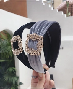 Detail of velvet headbands with sparkling square rhinestone buckles in black and grey