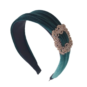Elegant dark green velvet ruched headband featuring a sparkling heart rhinestone buckle