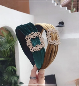 Detail of velvet wide headband with large square rhinestone buckle in green and brown