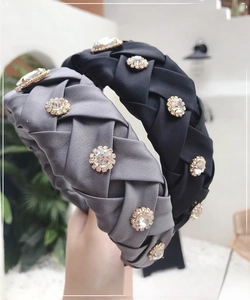 Detail of hand-woven satin headband with vintage round rhinestones and pleated texture