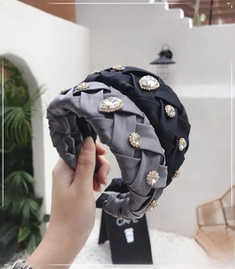 Detail of woven satin headbands with shimmering rhinestones and crisscross texture