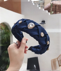 Detailed view of navy blue woven headband with large sparkling crystal rhinestones
